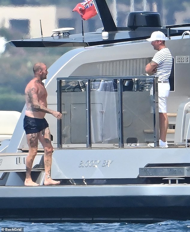David chatted to an aide on the boat following his impromptu photoshoot