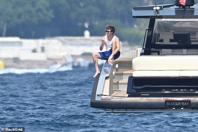 Cruz enjoyed a moment alone on the boat while using his phone