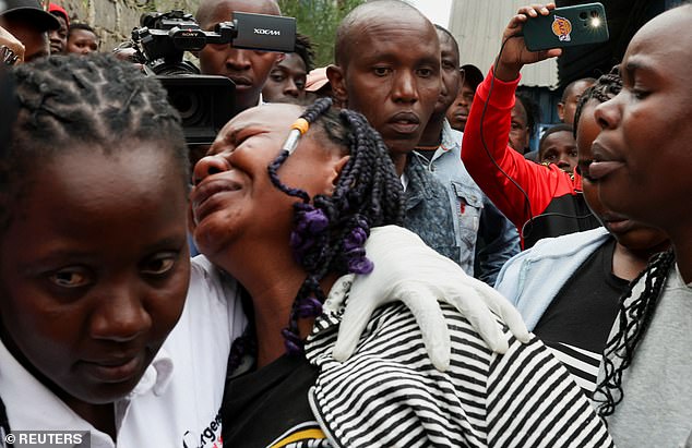 Pictured: People at the scene where the plane operated by AMREF Flying Doctors crashed into buildings