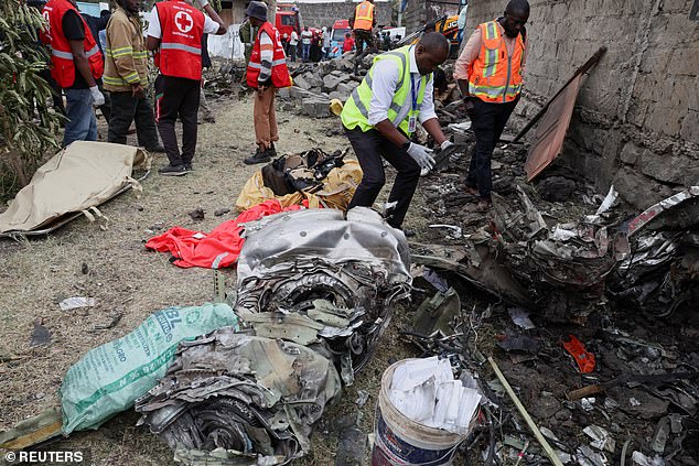Emergency services look through the rubble at the scene of the horrific incident