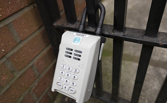 A key lock on a gate in Mayfair - the boxes are used to store keys for AirBnb guests