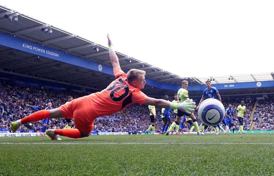 Soccer goalkeeper diving to save a goal.