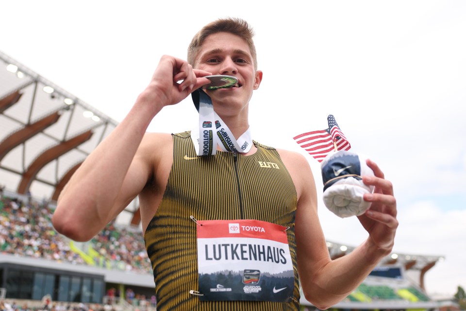 Silver medalist Cooper Lutkenhaus holding his medal and an American flag.