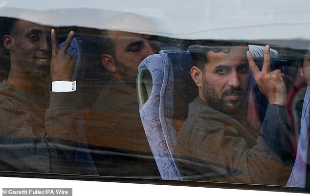 Some of the men gave peace signs as they were taken away in coaches
