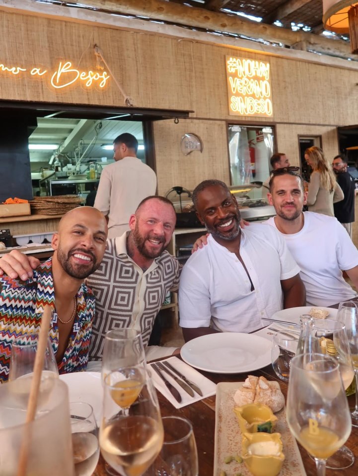Four men sitting together at a restaurant table.