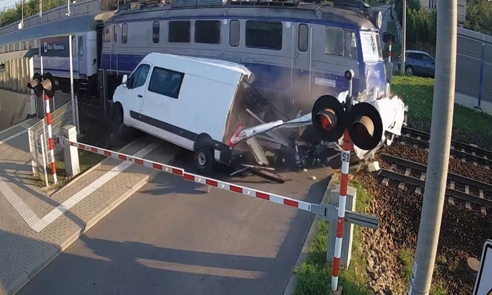 Train colliding with van at a railway crossing.