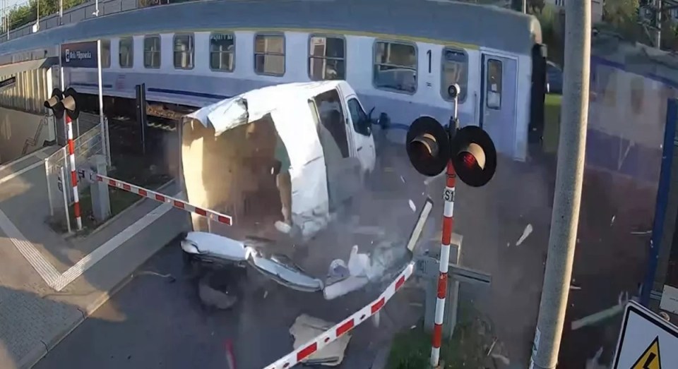 Train colliding with van at a railroad crossing.
