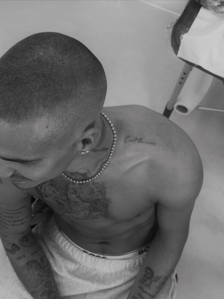 Black and white photo of Romeo Beckham's new "C'est la vie" tattoo.