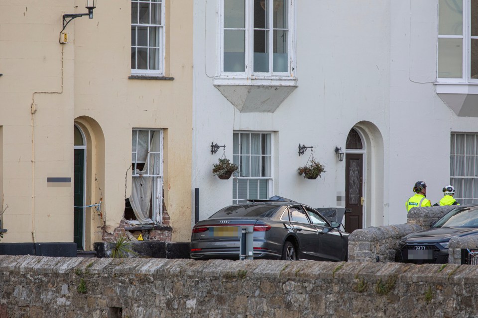 an audi car is parked in front of a building