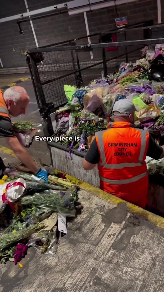Two workers carefully handling and sorting a large quantity of flowers.