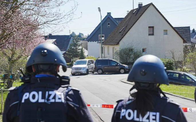 Police officers at the Schulze family murder scene in Weitefeld.