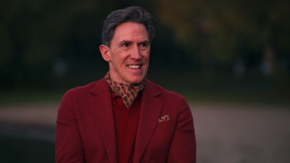 Rob Brydon in a red jacket.