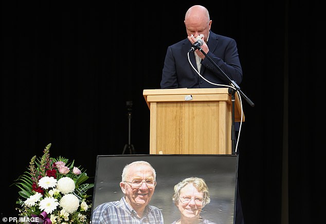 Simon Patterson breaks down at a memorial for his parents in 2023