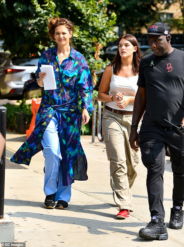 A black-clad PA with a walkie-talkie guided the mother-daughter duo down the sidewalk