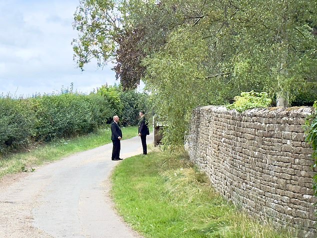 On the main gateway of the property, leading to a sweeping 'in and out' driveway, two suited security guards were checking the security clearance of those coming and going