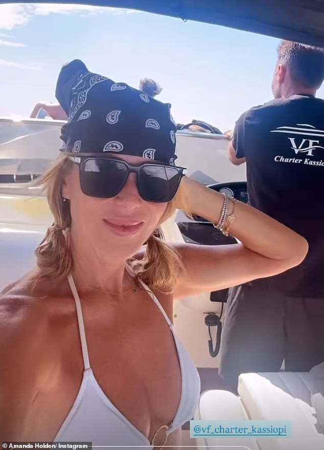 Amanda, who accessorised the look with a paisley print bandana and a pair of black wayfarer style shades, looked completely relaxed during her sunbathing session