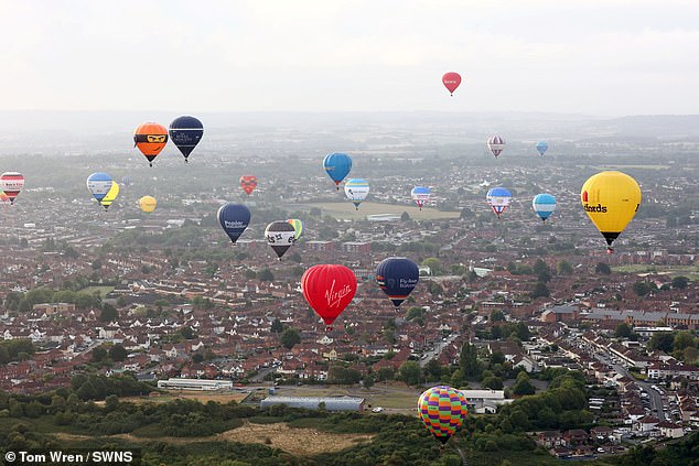 Balloons are seen taking off and heading into the skies of Bristol this morning as part of an international festival
