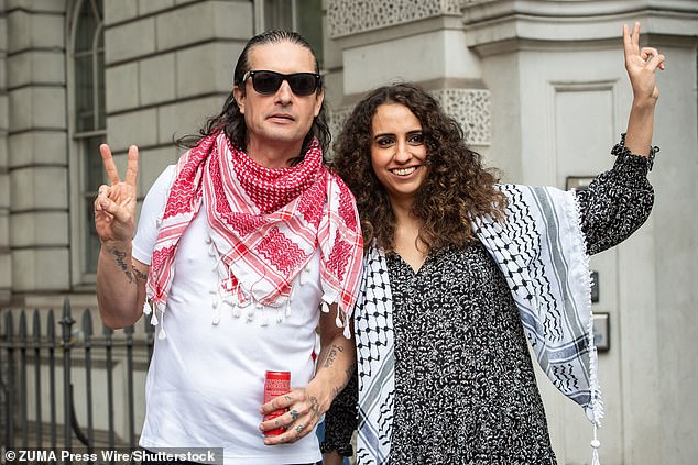 Palestine Action co-founders Richard Barnard and Huda Ammori stand outside Westminster Magistrates' Court