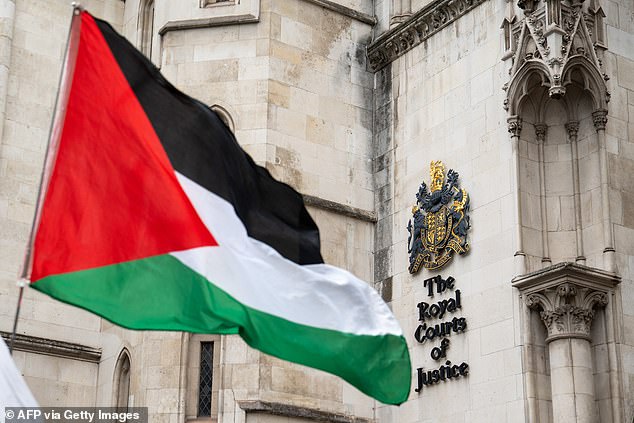 A Palestinian flag is seen held outside the Royal Courts of Justice in central London last month