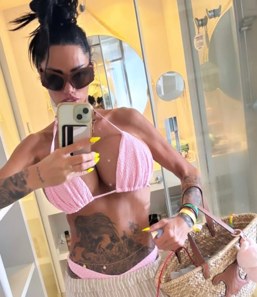 Katie Price in a pink bikini taking a selfie.