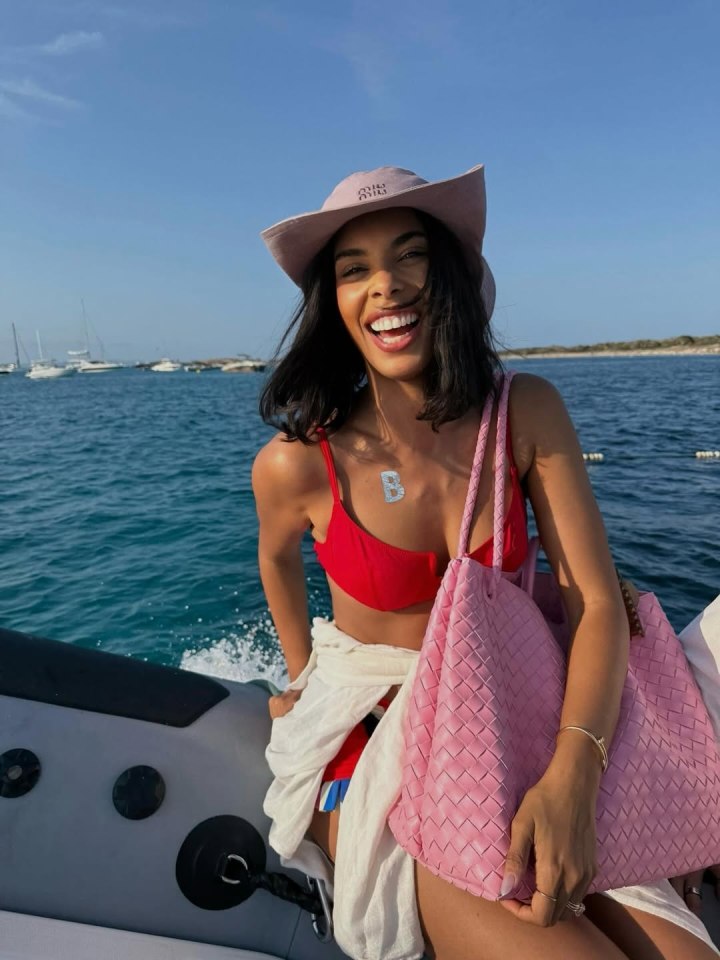 Rochelle Humes on a boat, wearing a red bikini and a hat.