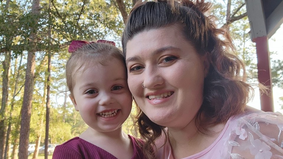 Photo of a woman and young girl smiling.
