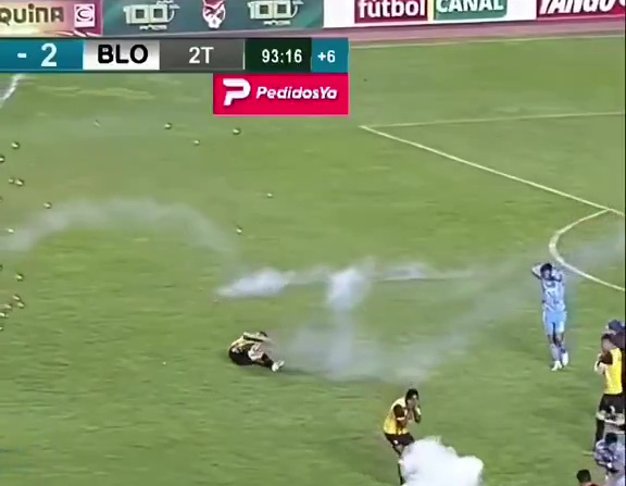 Football player collapsing after being hit by a firework.
