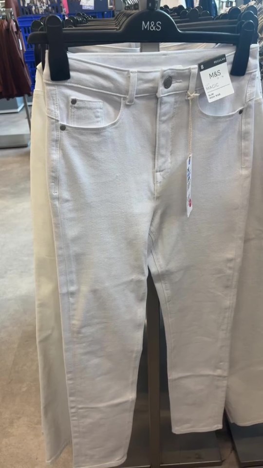 White M&S Magic jeans on a rack.