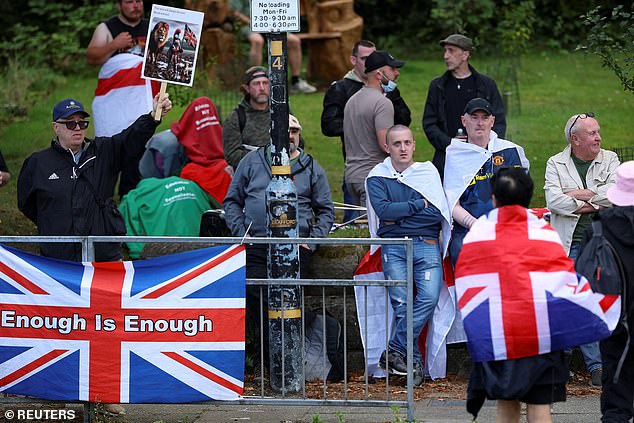 Others are holding placards which read 'enough is enough' against a Union Jack