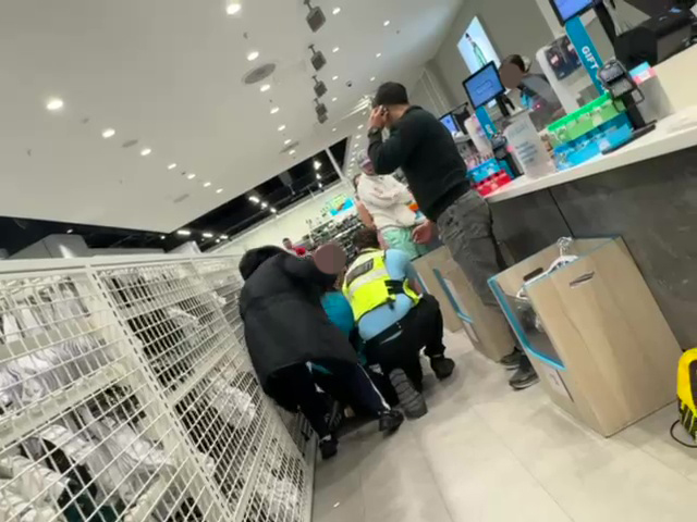 Security guards breaking up a fight between a Primark employee and a customer.