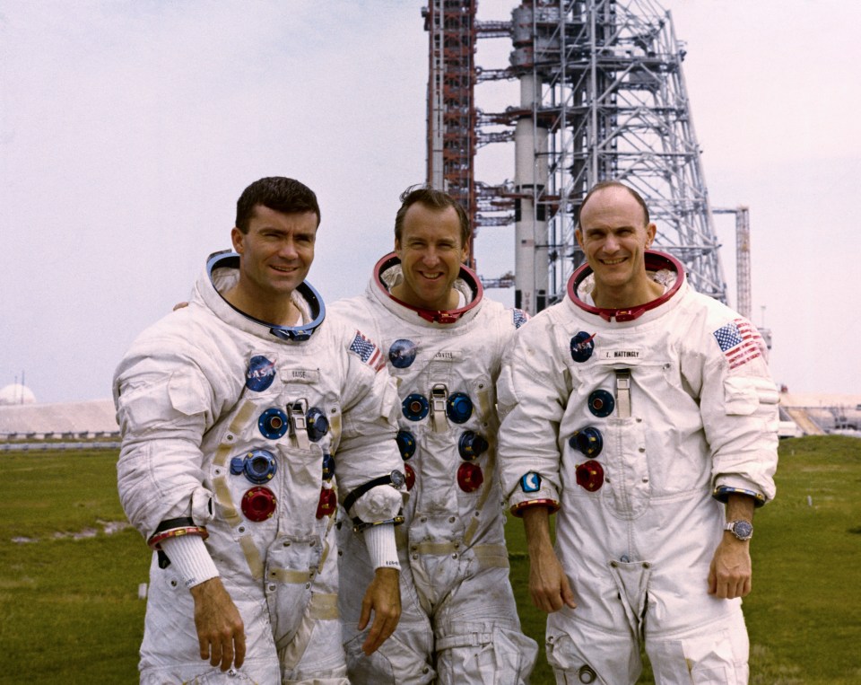Apollo 13 astronauts Fred Haise, Jim Lovell, and Ken Mattingly in spacesuits.