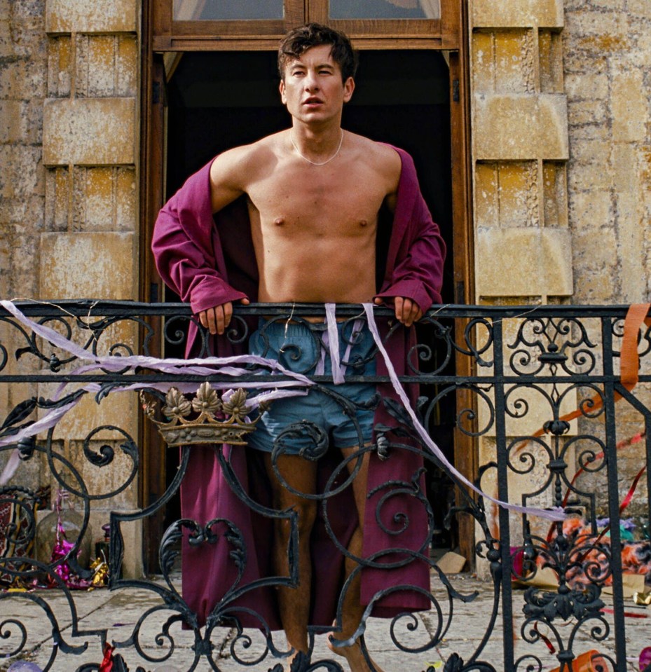 Still from the film *Saltburn*, showing Barry Keoghan on a balcony.