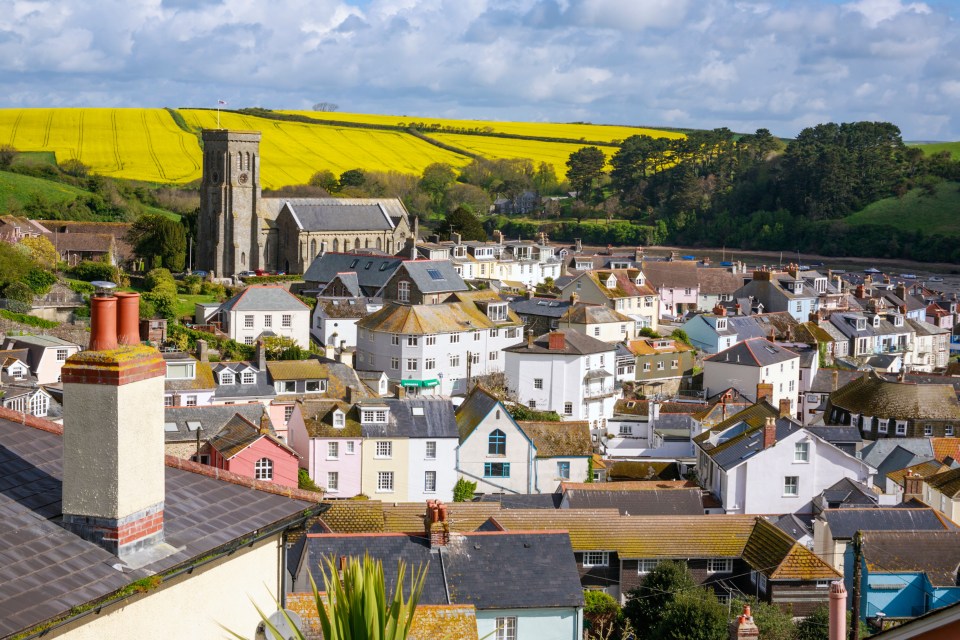 Aerial view of Salcombe, South Devon, with colorful houses and a church.