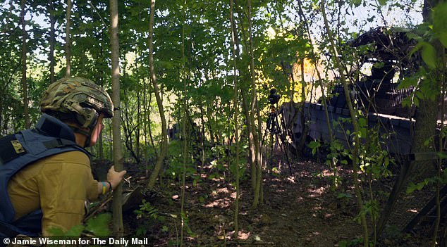 Richard peeks through a maple thicket between the first and 15th high-explosive rounds fired by the T-80 tank