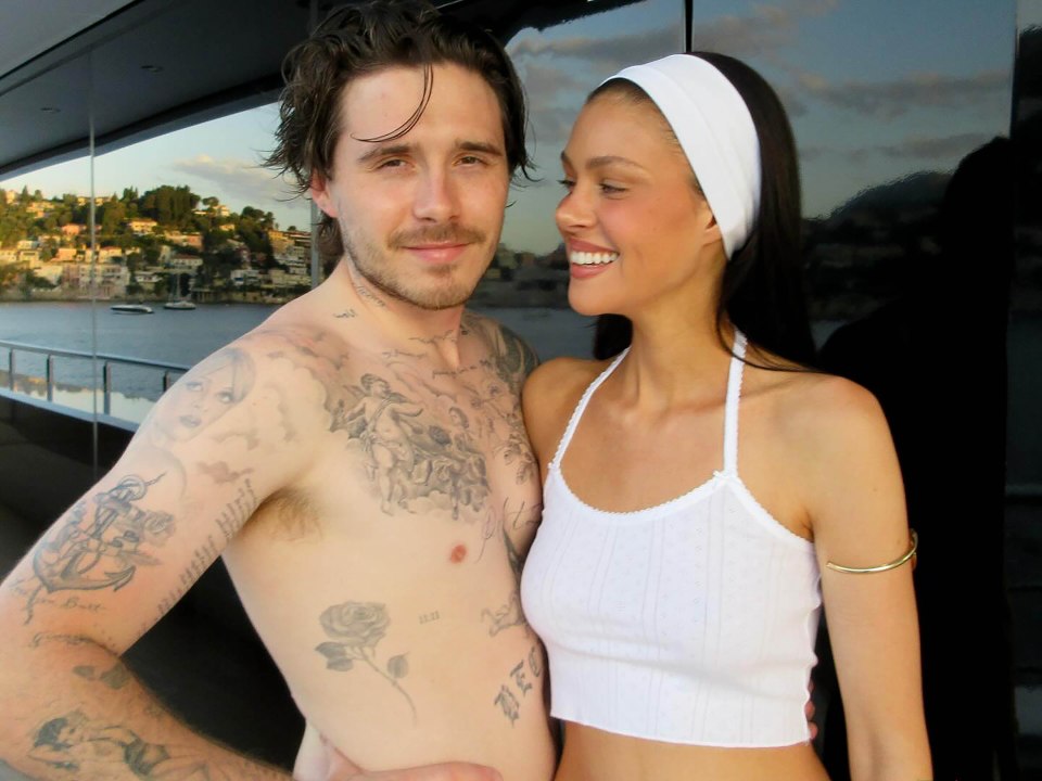 Nicola Peltz Beckham and Brooklyn Beckham embracing on a yacht.