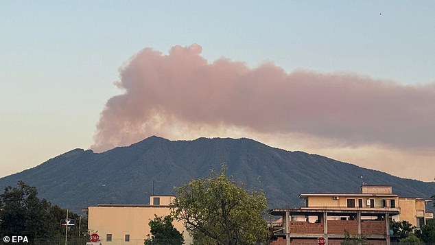 A tall column of smoke has risen into the sky and is visible from Naples