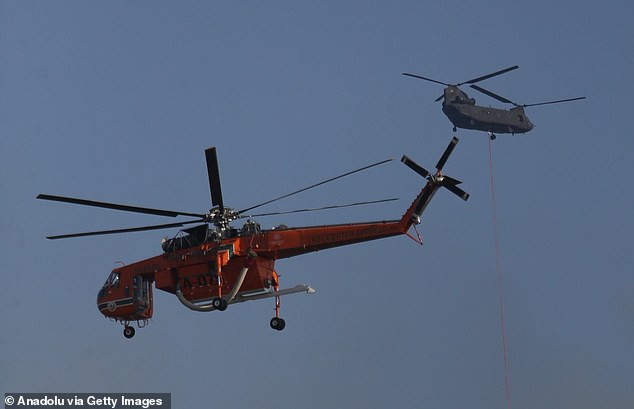 Crews intervene in a wildfire, which spreads from farmland into forested areas in Canakkale, Turkiye on August 08, 2025
