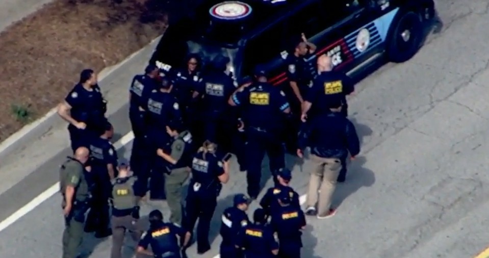 Police officers surrounding a suspect near Emory University.