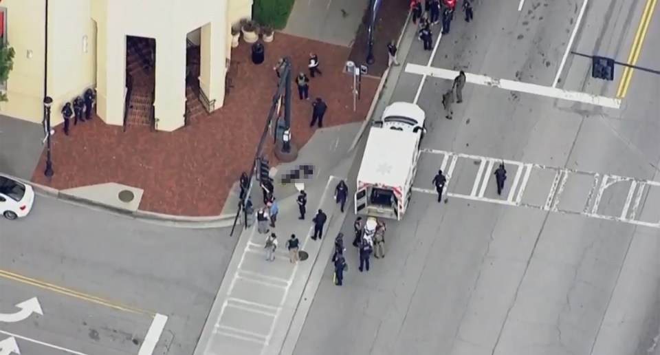 Aerial view of a crime scene with police and an ambulance.
