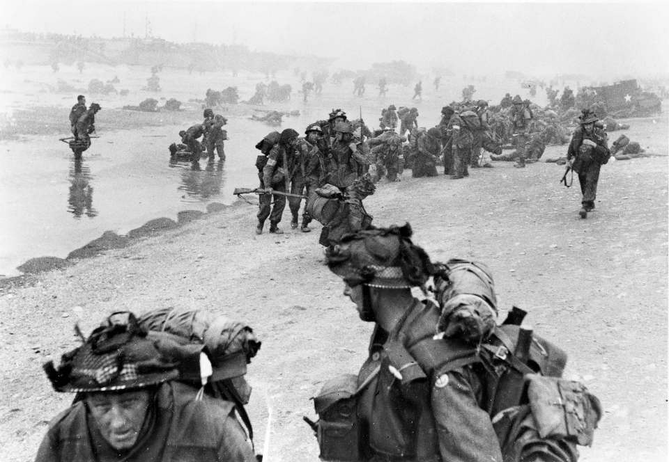 British soldiers landing on Normandy beach during World War II.