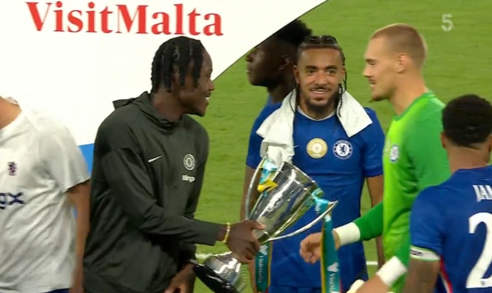 Chelsea players with trophy.