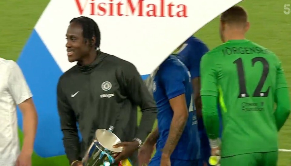 Soccer player holding a trophy.
