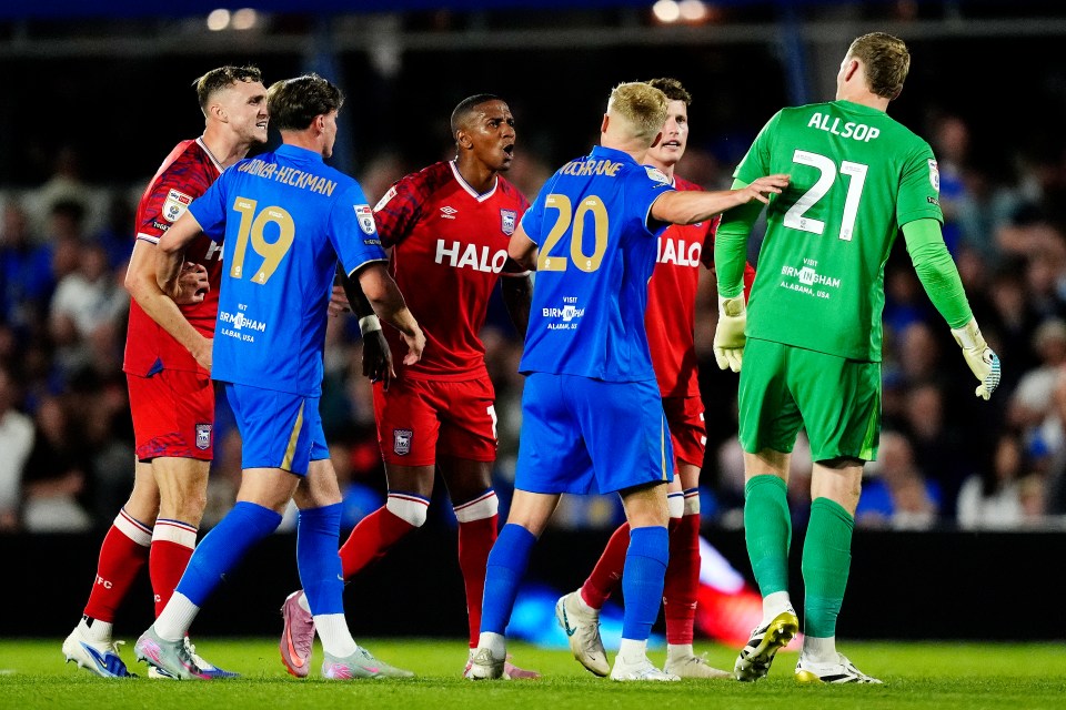 Soccer players arguing on the field.