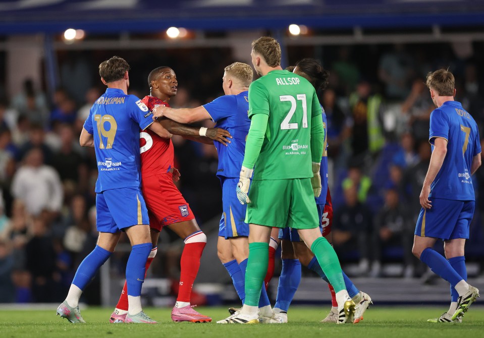 Soccer players in a heated moment on the field.