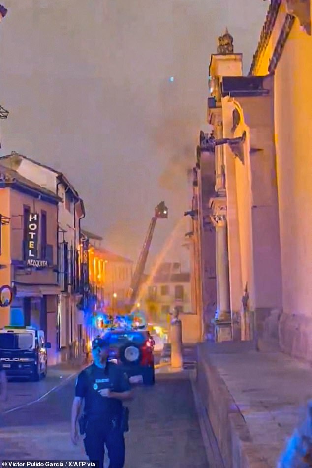 Dramatic footage shows thick smoke billowing out from the historic UNESCO-listed mosque-cathedral of Cordoba on Friday night, as flames lapped at its roof