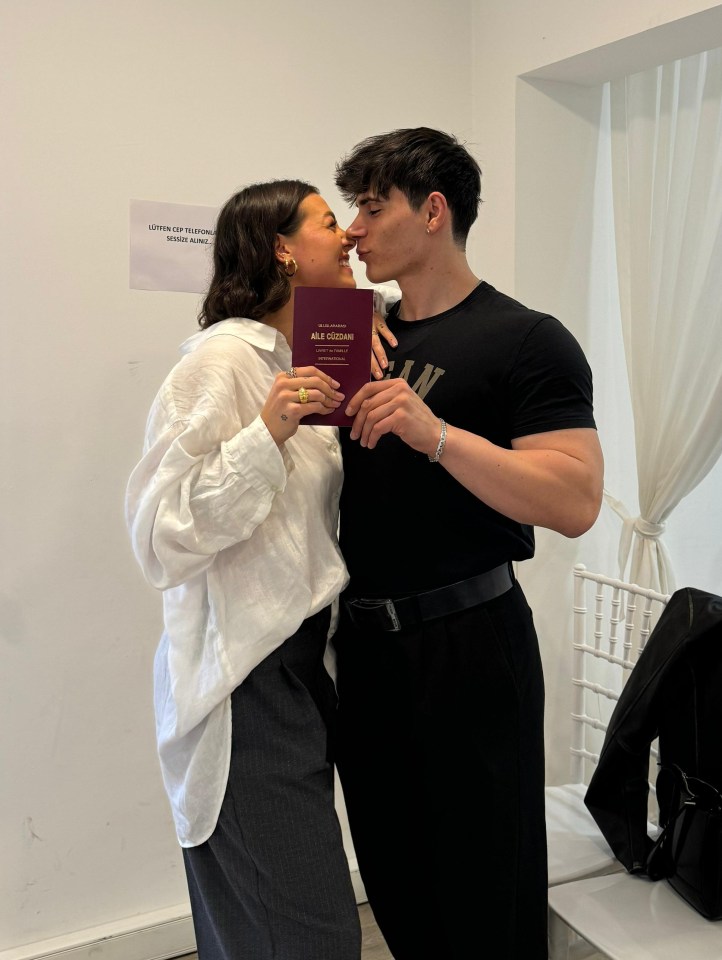 Newlyweds holding their marriage certificate.