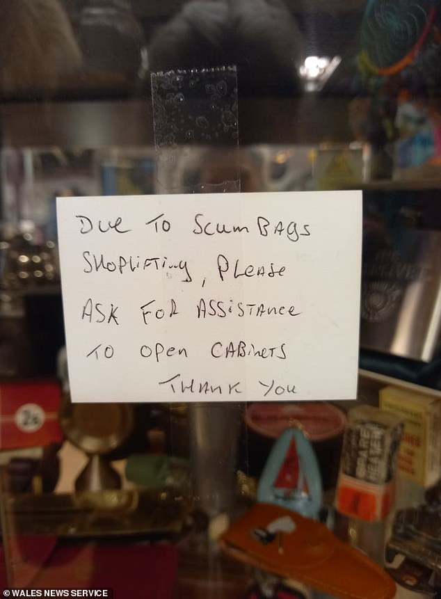 Rob Davies, 61, who runs the Run Ragged vintage shop in Wrexham, North Wales, installed the notice (pictured) to tell shoppers some cabinets were locked against theft