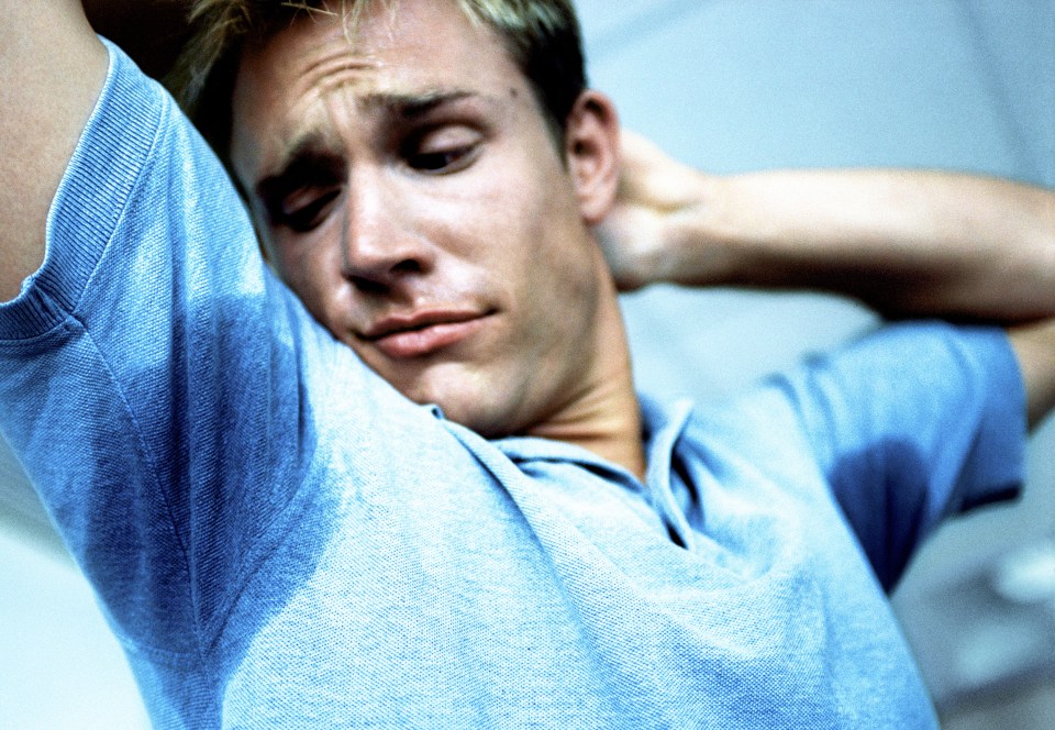 Man sweating profusely under his arms.