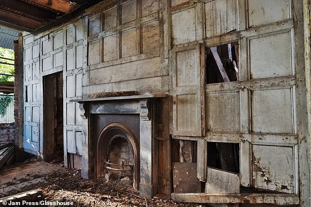 The above image shows a fireplace in the middle of what would formerly have been a lounge area