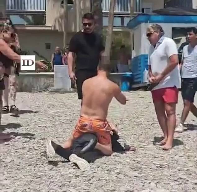 Pictured: Granada bathers hold back disembarked immigrants on Sotillo beach in Castell de Ferro